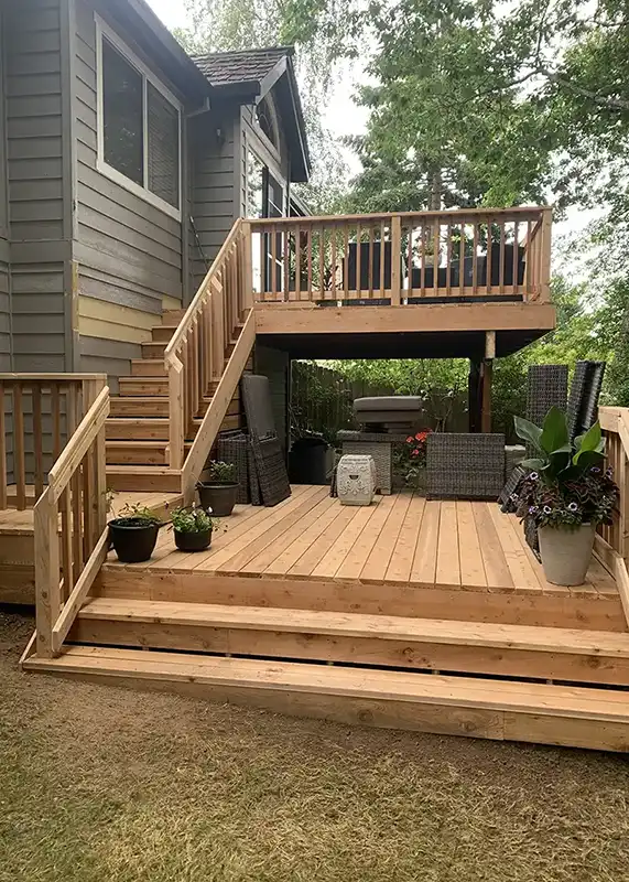 Cedar deck with wood steps leading to the yard.