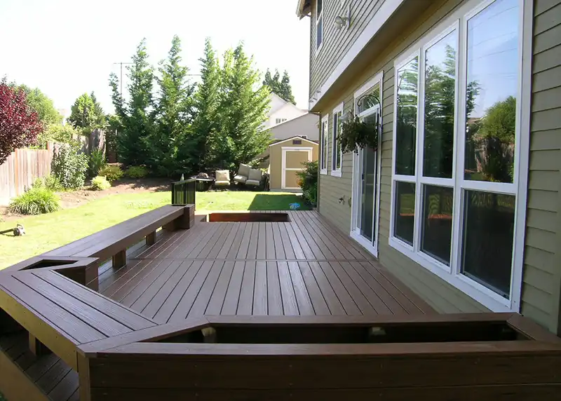 Custom deck with built in benches and hot tub cutout at a Portland area home