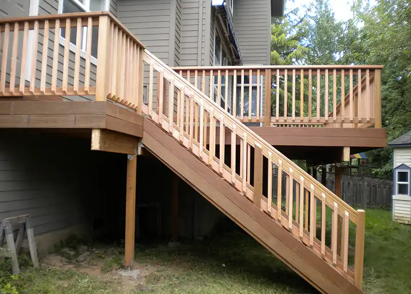 Ipe hardwood deck paired with cedar railing overlooking a wooded residential property in Portland Oregon