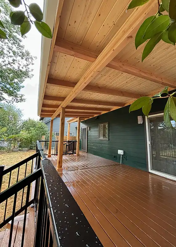 Patio cover paired with aluminum deck railing along a residential edge.